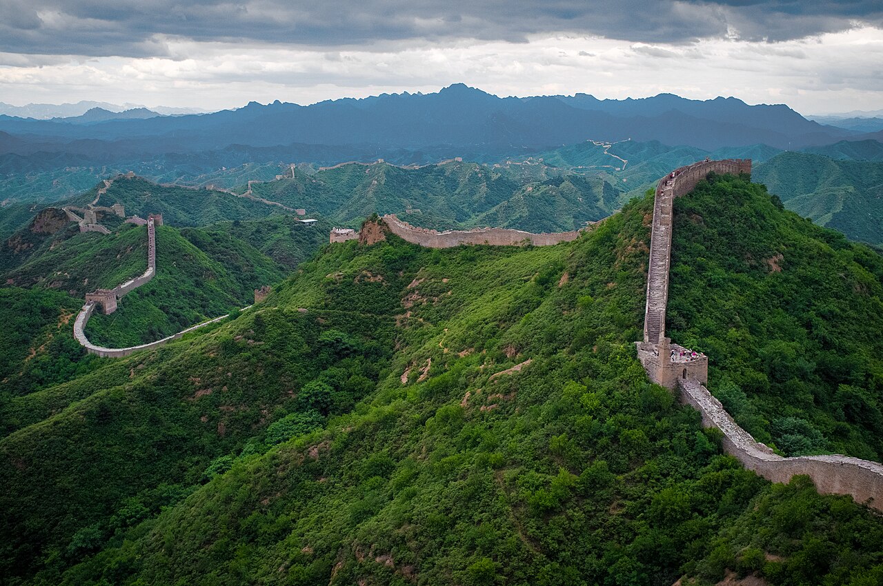 The Great Wall of China snaking over green mountains at Jinshanling